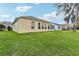 The yard is spacious, featuring a well-manicured lawn that extends to the neighboring properties at 5135 Aurora Dr, Leesburg, FL 34748