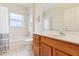 Bright bathroom featuring a shower-tub combo, vanity, and natural light for a refreshing feel at 5135 Aurora Dr, Leesburg, FL 34748