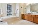 Spacious bathroom featuring a soaking tub, large window, and ample counter space for added convenience at 5135 Aurora Dr, Leesburg, FL 34748