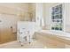 Bathroom featuring a separate shower and tub, ample natural light, and elegant tile throughout the space at 5135 Aurora Dr, Leesburg, FL 34748