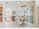 Cozy dining area with sliding glass doors offering natural light and views of the outdoor lanai at 5135 Aurora Dr, Leesburg, FL 34748