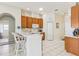 Open kitchen with a breakfast bar, white countertops, and oak cabinetry at 5135 Aurora Dr, Leesburg, FL 34748