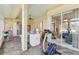 Enclosed lanai with wicker furniture, access to interior rooms, ceiling fan, and exterior views at 5135 Aurora Dr, Leesburg, FL 34748