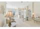 Bright living room with large windows, chandelier, and neutral decor providing an open and airy atmosphere at 5135 Aurora Dr, Leesburg, FL 34748