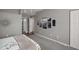 This cozy bedroom features a modern accent wall art, closet and doorway to the bathroom at 5466 Compass Pt # 101, Oxford, FL 34484