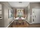 A stylish dining room features a modern table, pendant lighting, and warm, neutral tones at 5466 Compass Pt # 101, Oxford, FL 34484
