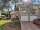 Charming home with a tile roof, well-manicured landscaping, and a two-car garage at 5466 Compass Pt # 101, Oxford, FL 34484