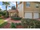 Charming home featuring a brick walkway, two-car garage and terra cotta tile roof at 5466 Compass Pt # 101, Oxford, FL 34484
