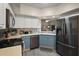 Updated kitchen with stainless steel appliances, two-tone cabinets, and open to living area at 5466 Compass Pt # 101, Oxford, FL 34484