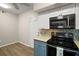 Well-lit kitchen features stainless steel microwave, updated counters and appliances at 5466 Compass Pt # 101, Oxford, FL 34484