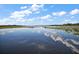 Scenic view of lake reflecting the blue sky and clouds above at 5466 Compass Pt # 101, Oxford, FL 34484