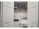 Laundry room with washer, dryer, and shelving for organized storage space at 5466 Compass Pt # 101, Oxford, FL 34484