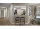 A warm and inviting living room and bar with modern stools and stylish decor at 5466 Compass Pt # 101, Oxford, FL 34484