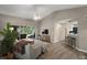Spacious living room with vaulted ceilings, wood floors and sliding glass doors to the back patio at 5466 Compass Pt # 101, Oxford, FL 34484