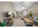 Open concept living space with a large TV, bar seating, dining area, and comfortable seating at 5466 Compass Pt # 101, Oxford, FL 34484