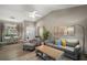 Inviting living room with wood-look floors, views to the dining room, and a door to the entry at 5466 Compass Pt # 101, Oxford, FL 34484