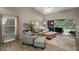 Cozy living room featuring modern wood-look floors, bright light, and a view to the patio at 5466 Compass Pt # 101, Oxford, FL 34484