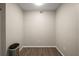 A clean and well-lit living space with neutral walls and wood-look floors at 5466 Compass Pt # 101, Oxford, FL 34484