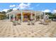 Outdoor bar and gathering area with ample seating, a bar, and stylish design in a residential community at 5466 Compass Pt # 101, Oxford, FL 34484