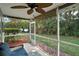 Screened porch offering outdoor views, a ceiling fan, and comfortable seating at 5466 Compass Pt # 101, Oxford, FL 34484