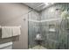 This walk-in shower has stylish tile, built-in bench and niche, and glass doors at 5466 Compass Pt # 101, Oxford, FL 34484
