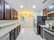 Well-lit kitchen with dark cabinets, granite countertops, and stainless steel appliances at 5891 Forest Ridge Dr, Winter Haven, FL 33881