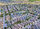 Scenic aerial view of a vibrant neighborhood showcasing diverse home styles, palm trees, and well-planned street layouts at 591 Statesburg St, The Villages, FL 32162