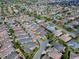 Drone photo showcasing an inviting property within a serene neighborhood, complemented by lush landscaping and sidewalks at 591 Statesburg St, The Villages, FL 32162