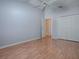 Bright bedroom with light gray walls, wood floors, closet, and a ceiling fan at 591 Statesburg St, The Villages, FL 32162