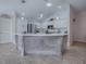 A large kitchen island anchors the space, offering a focal point with its intricate design and pendant lighting at 591 Statesburg St, The Villages, FL 32162