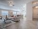 Spacious living room boasts an open layout that connects the kitchen and dining areas for easy flow and social interaction at 591 Statesburg St, The Villages, FL 32162