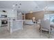 Open-concept living area connects the kitchen, dining, and sitting areas, promoting an inclusive and airy atmosphere at 591 Statesburg St, The Villages, FL 32162