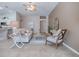 Comfortable living room features stylish decor, ceiling fan and an open layout with kitchen views at 591 Statesburg St, The Villages, FL 32162