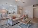 Bright and airy living room boasts neutral tones, a decorative ceiling fan and an open layout at 591 Statesburg St, The Villages, FL 32162