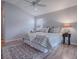 Comfortable main bedroom boasts a ceiling fan, a neutral color palette and wood floors at 591 Statesburg St, The Villages, FL 32162