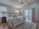 Bright main bedroom featuring vaulted ceiling, sliding glass doors and hardwood flooring at 591 Statesburg St, The Villages, FL 32162