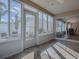 Enclosed sunroom with lots of windows, ceiling fan, and stylish furniture at 591 Statesburg St, The Villages, FL 32162