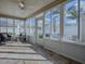 Enclosed sunroom with lots of windows, ceiling fan, and stylish furniture at 591 Statesburg St, The Villages, FL 32162