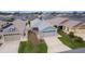 Aerial view of a well-maintained house with green lawn, landscaping, and a two-car garage at 5934 Kaplan Ct, The Villages, FL 32163