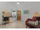 Office/bedroom featuring a desk, display cabinet, cozy chair, and light wood flooring at 5934 Kaplan Ct, The Villages, FL 32163