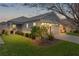 Beautiful home illuminated at dusk with lush landscaping and inviting lighting at 5934 Kaplan Ct, The Villages, FL 32163
