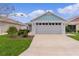 Charming home featuring a two-car garage, well-maintained landscaping and inviting curb appeal at 5934 Kaplan Ct, The Villages, FL 32163