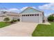 Attractive home with a two-car garage, well-manicured lawn, and inviting driveway at 5934 Kaplan Ct, The Villages, FL 32163