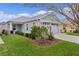 Charming home with a manicured lawn, well-kept landscaping, and a two-car garage at 5934 Kaplan Ct, The Villages, FL 32163