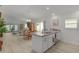 Open concept kitchen with stainless steel appliances, modern countertops, and seamless flow to living spaces at 5934 Kaplan Ct, The Villages, FL 32163