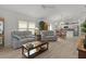 Open concept living space with neutral decor, lots of seating, and access to the kitchen at 5934 Kaplan Ct, The Villages, FL 32163