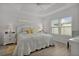 Inviting main bedroom with tray ceiling, neutral walls, ceiling fan, and plush bedding at 5934 Kaplan Ct, The Villages, FL 32163