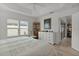 Spacious bedroom with ceiling fan, plantation shutters, wood-look floors, and a walk-in closet at 5934 Kaplan Ct, The Villages, FL 32163