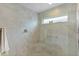 Shower featuring large tiles, a built-in bench, and a window for natural light at 5934 Kaplan Ct, The Villages, FL 32163