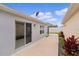 Exterior view of home showing side yard with sliding glass doors and satellite dish at 5934 Kaplan Ct, The Villages, FL 32163